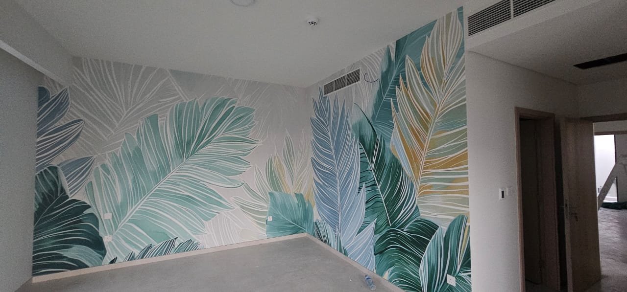 Tropical leaf mural wallpaper design in a Dubai living room